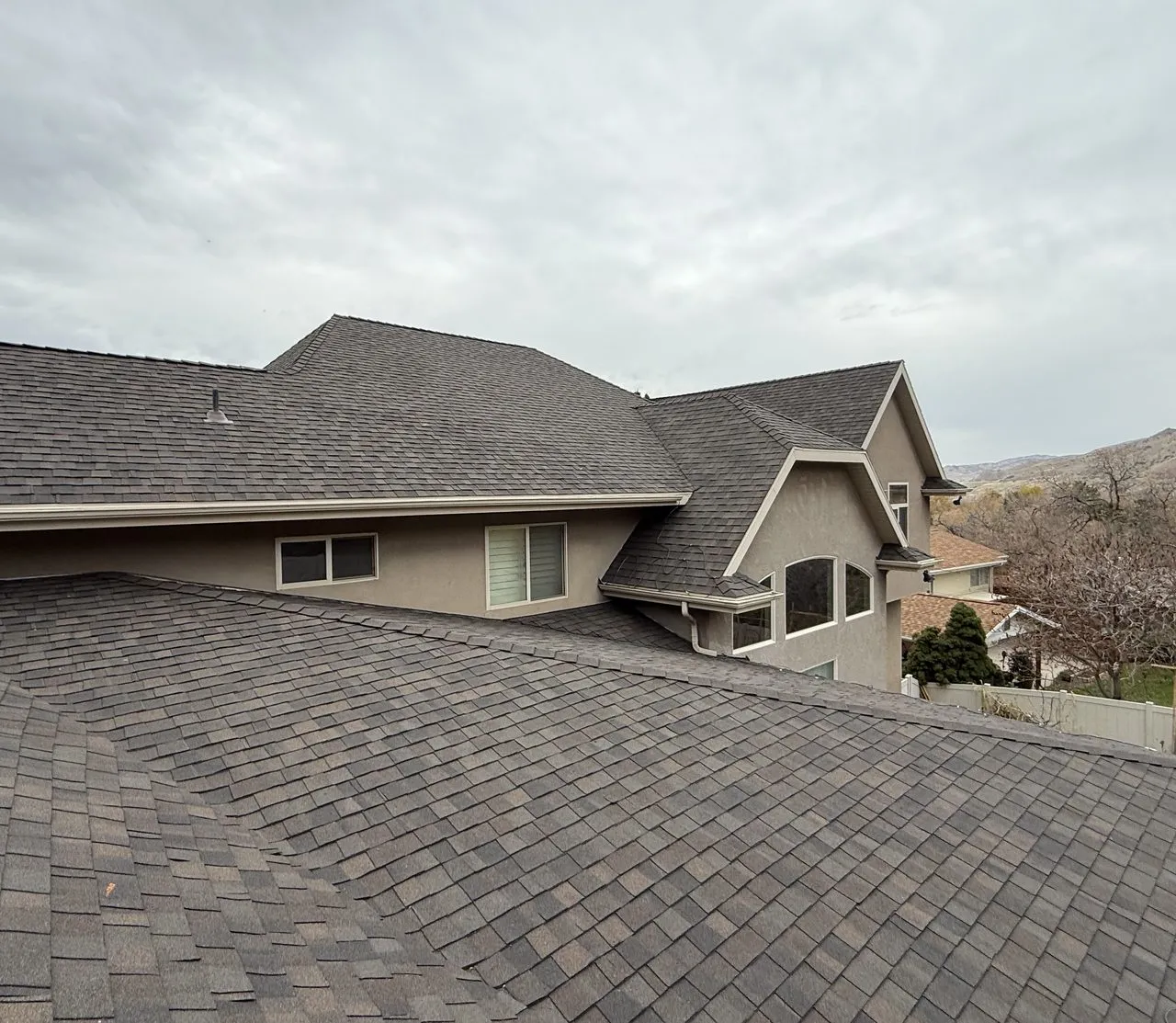 Ogden roof with wind damage - torn shingles and exposed underlayment repaired by Frame Roofing Utah crew