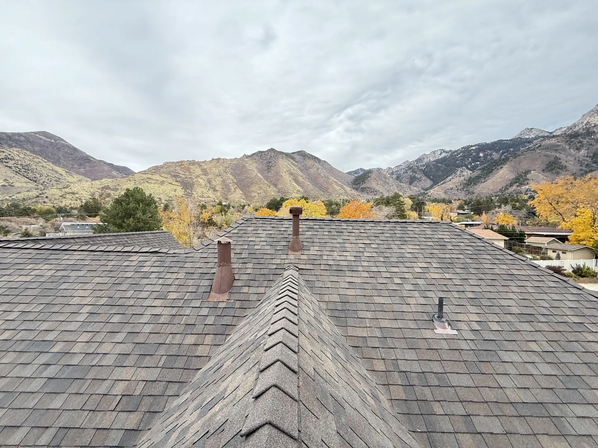 Completed residential roof replacement in Holladay, Utah with Wasatch Mountain views — Frame Roofing Utah
