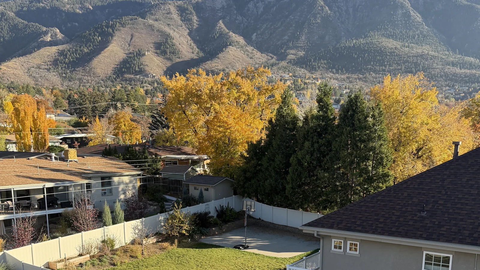 Mt. Olympus and Salt Lake Valley east-bench premium home reroof by Frame Roofing Utah — autumn canopy, established neighborhood
